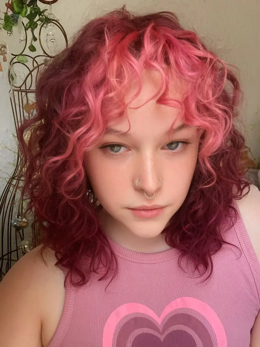 Curly Haircuts - Natural Curls Inspiration Summer 2025 Bold Pink and Magenta Curls with Playful Bangs