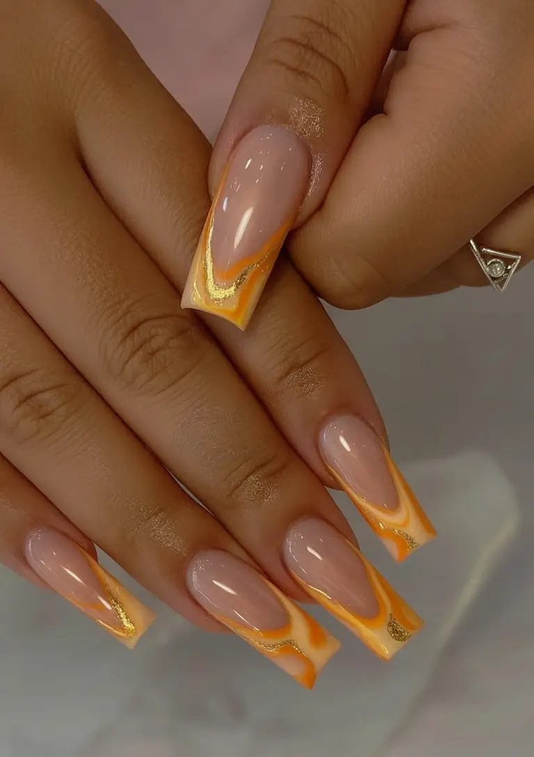 Summer 2025 Nail Designs to Try Sunset Swirl Tips With A Golden Edge