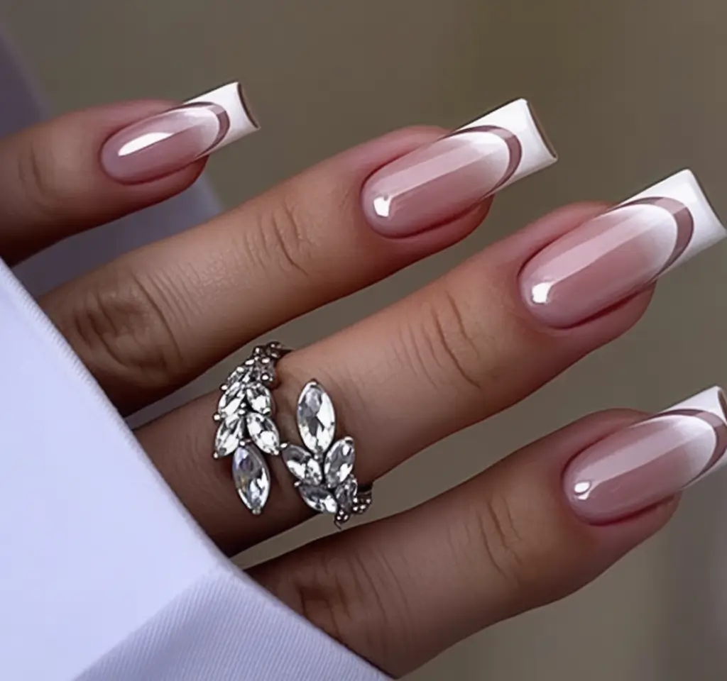 Summer 2025 Nail Designs to Try Double White Curve French For The Minimal Queens